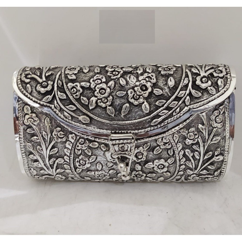 maanniya pure silver clutch with stylish lock in antique work.